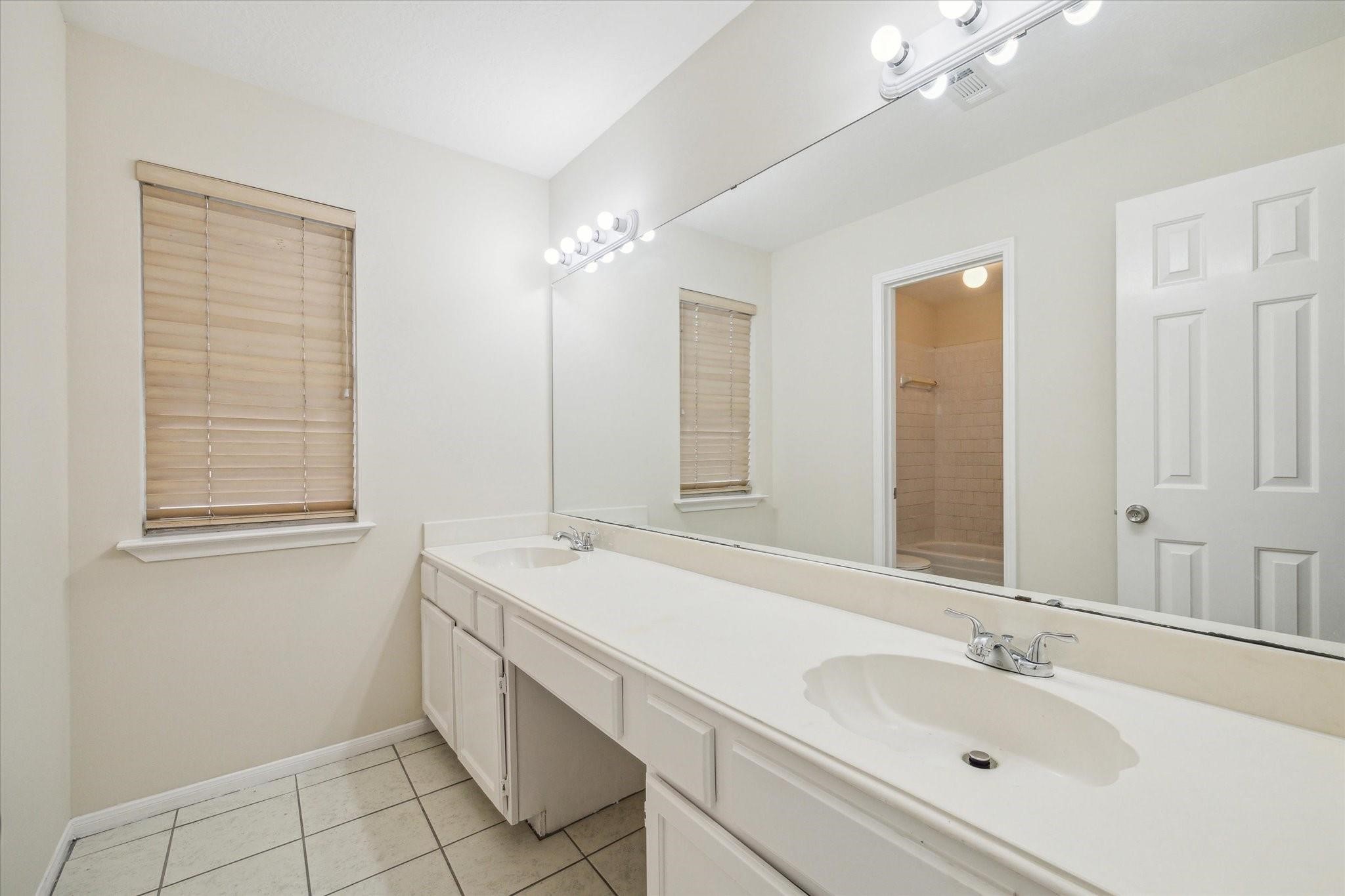 16403 Wellers Way Houston, TX 77095 - Photo 23 of 26 a bathroom with a sink double vanity and a mirror