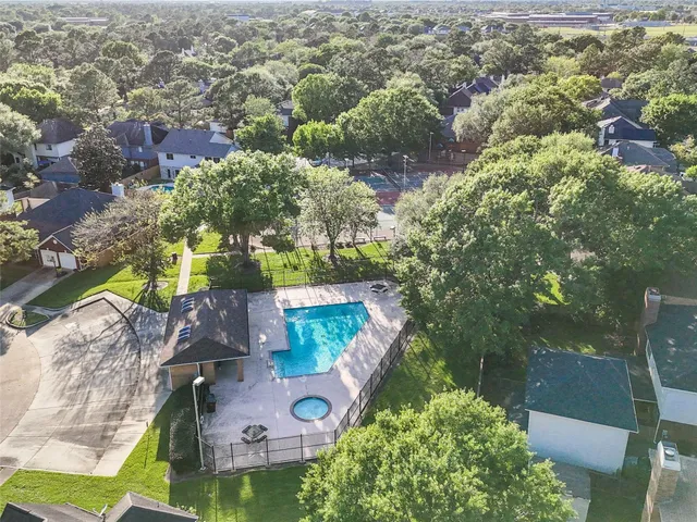 an aerial view of residential houses with outdoor space