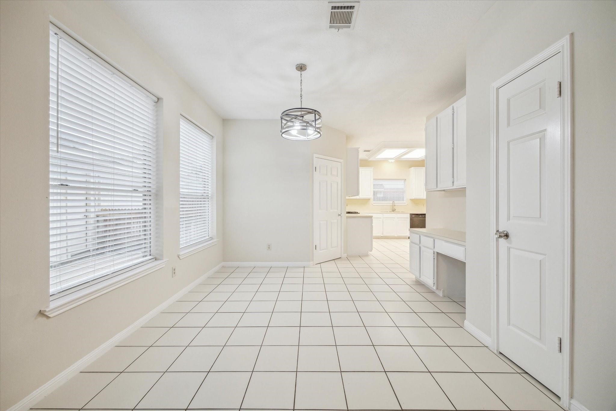 16403 Wellers Way Houston, TX 77095 - Photo 7 of 26 a view of a kitchen with a white cabinets and window