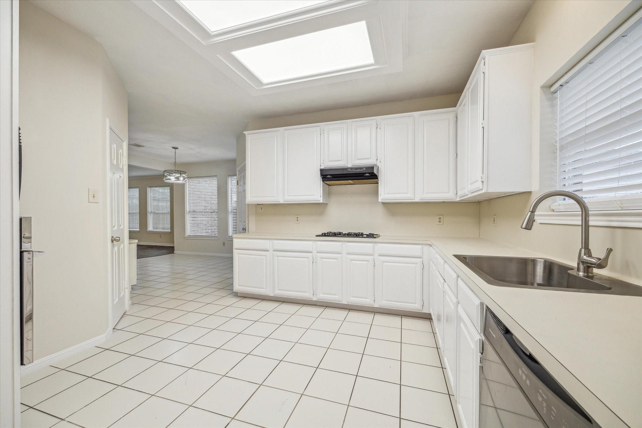 16403 Wellers Way Houston, TX 77095 - Photo 9 of 26 a kitchen with a sink cabinets and appliances