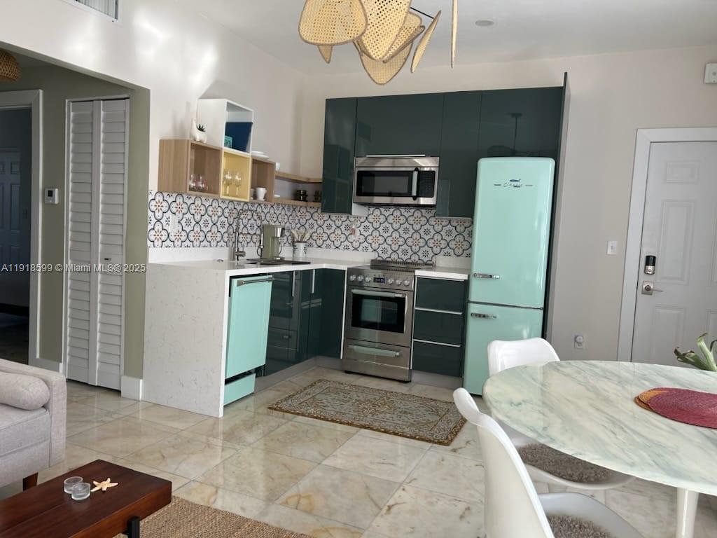 801 8th Street, Unit 201 Miami Beach, FL 33139 - Photo 16 of 37 a bedroom with a bed and a television