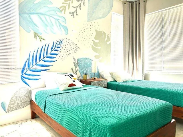 a bedroom with a bed and windows