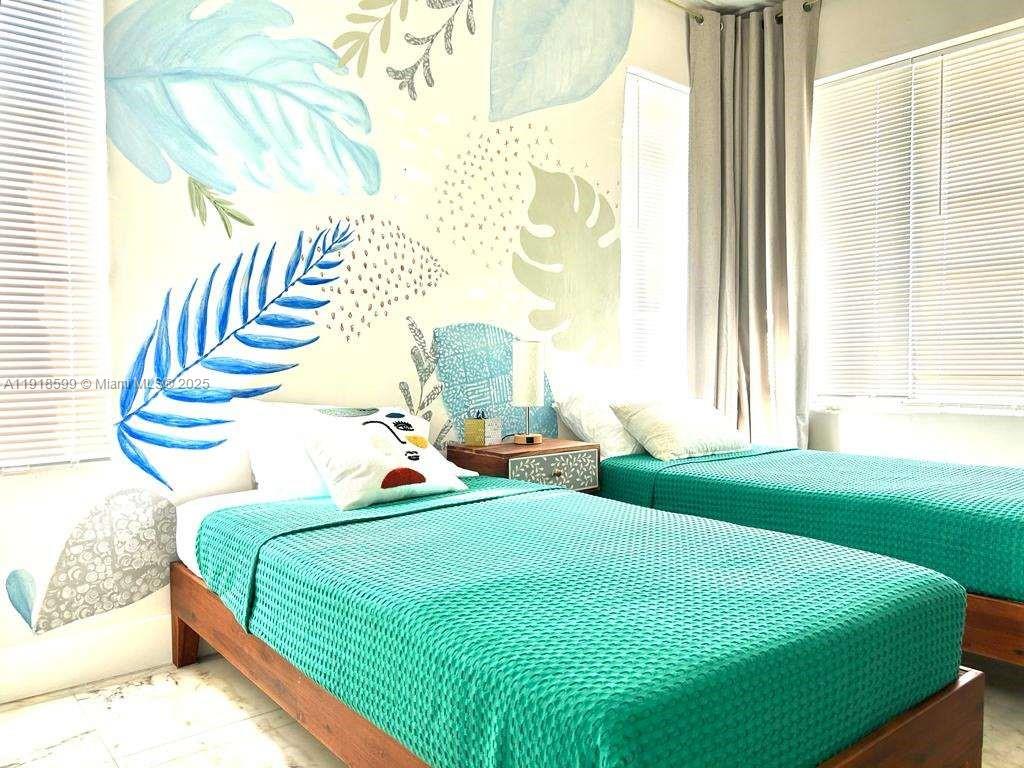 801 8th Street, Unit 201 Miami Beach, FL 33139 - Photo 19 of 37 a bedroom with a bed and windows