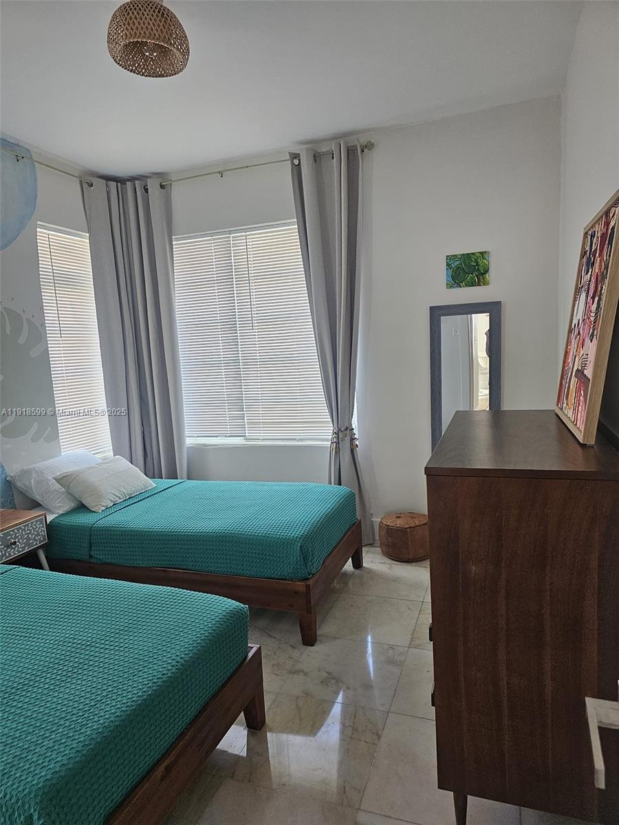 801 8th Street, Unit 201 Miami Beach, FL 33139 - Photo 20 of 37 a living room with furniture and a window