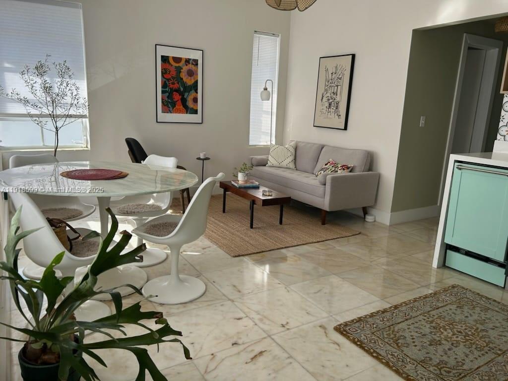 801 8th Street, Unit 201 Miami Beach, FL 33139 - Photo 2 of 37 a living room with furniture and a rug