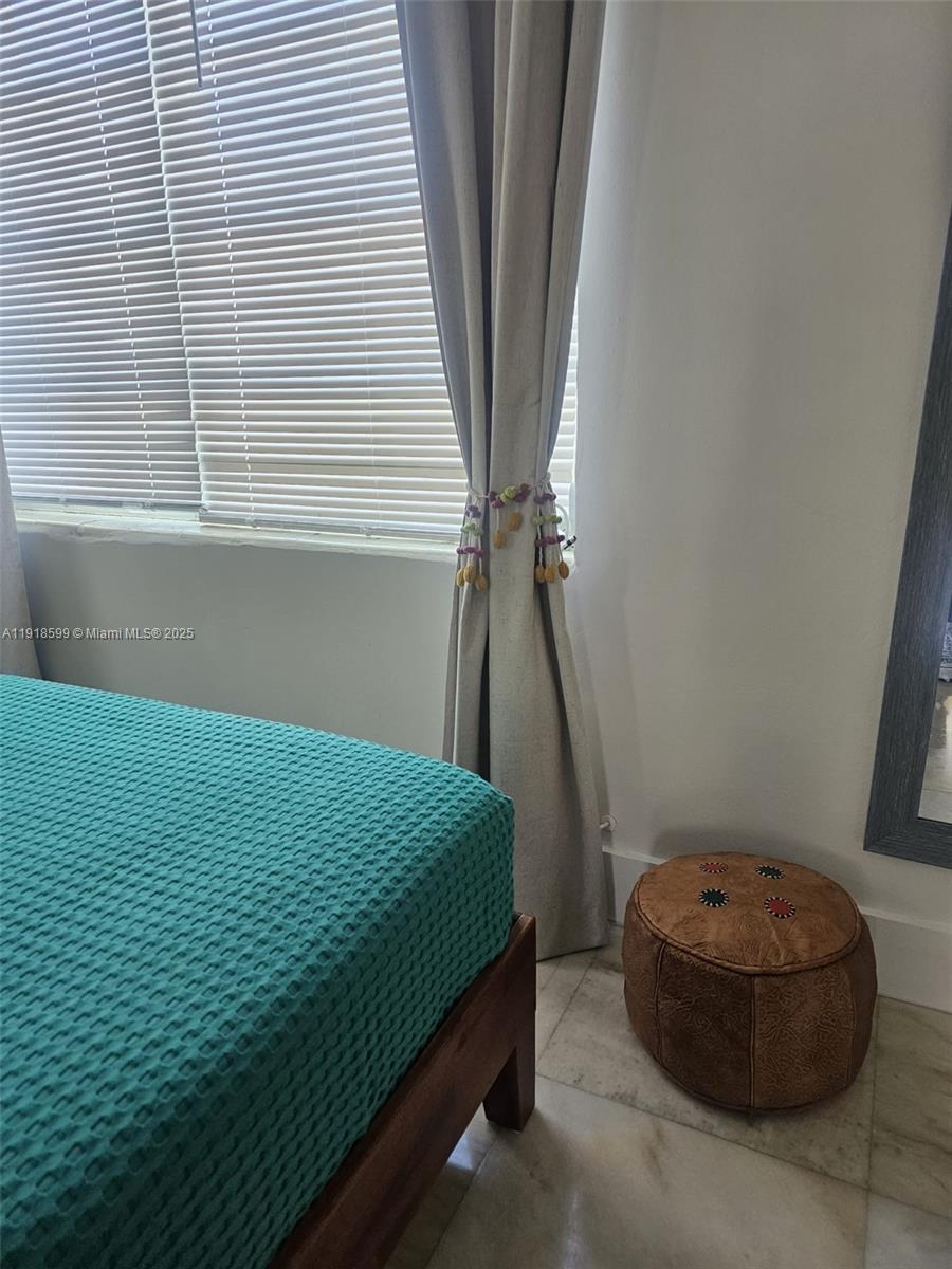 801 8th Street, Unit 201 Miami Beach, FL 33139 - Photo 21 of 37 a bedroom with a bed and a window