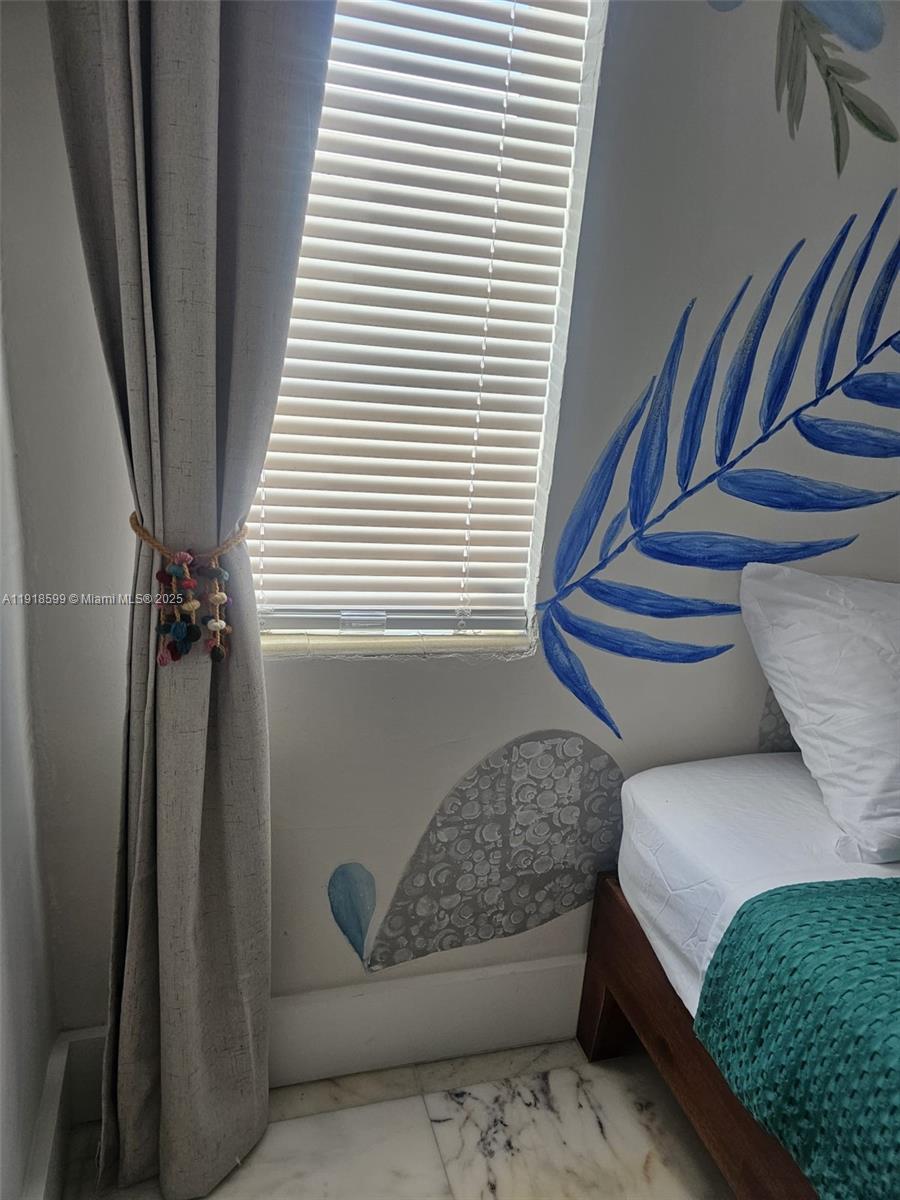 801 8th Street, Unit 201 Miami Beach, FL 33139 - Photo 22 of 37 a bedroom with a bed and a window