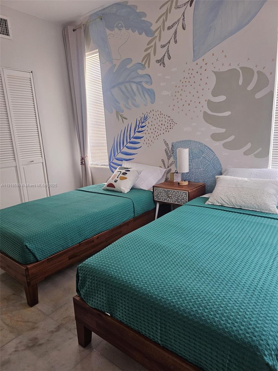 801 8th Street, Unit 201 Miami Beach, FL 33139 - Photo 24 of 37 a bedroom with two beds and painted walls