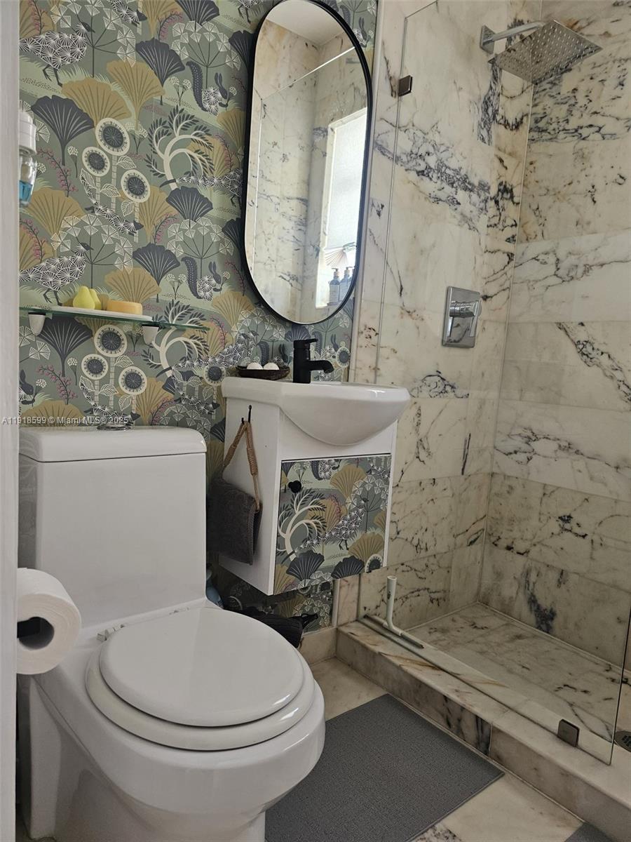 801 8th Street, Unit 201 Miami Beach, FL 33139 - Photo 27 of 37 a bathroom with a toilet and a sink