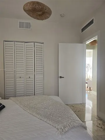 a bedroom with a bed and a view of bathroom