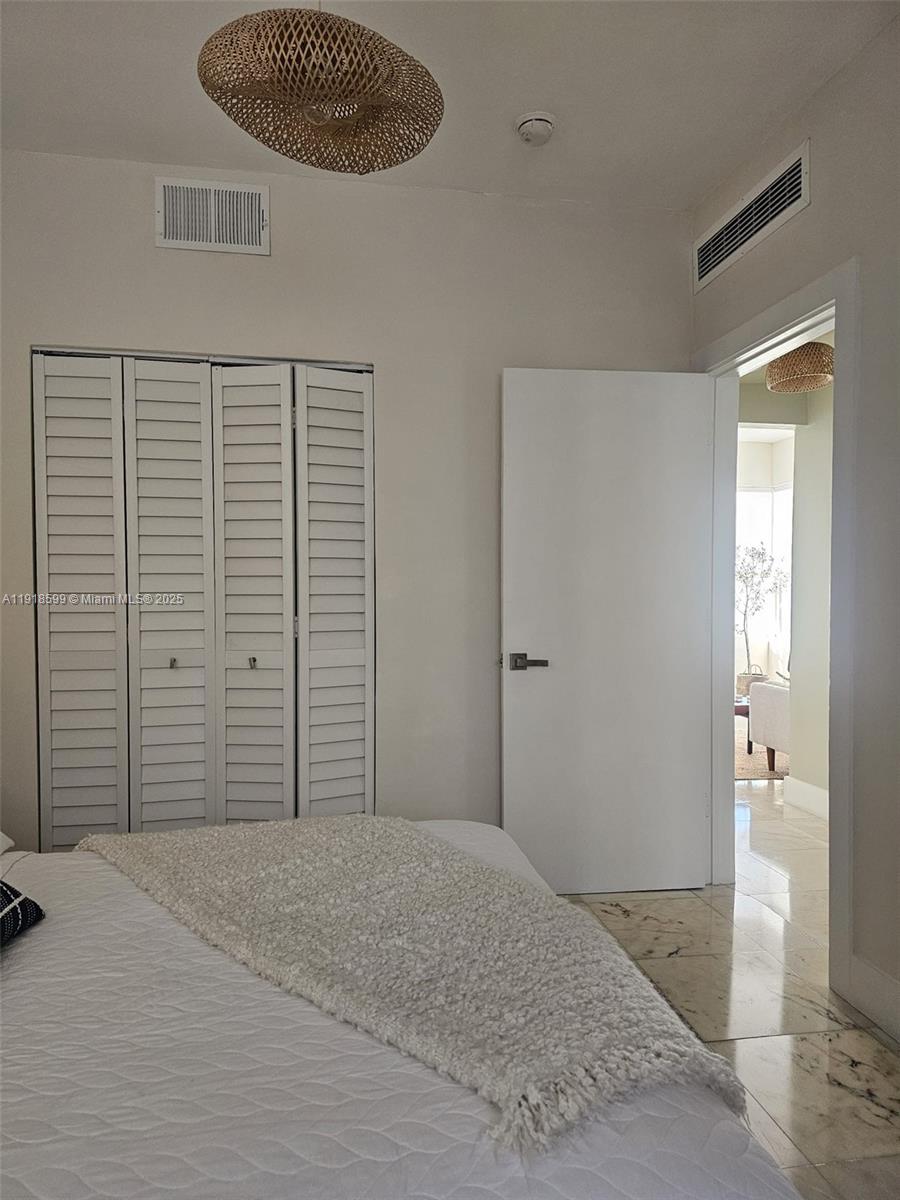 801 8th Street, Unit 201 Miami Beach, FL 33139 - Photo 28 of 37 a bedroom with a bed and a view of bathroom