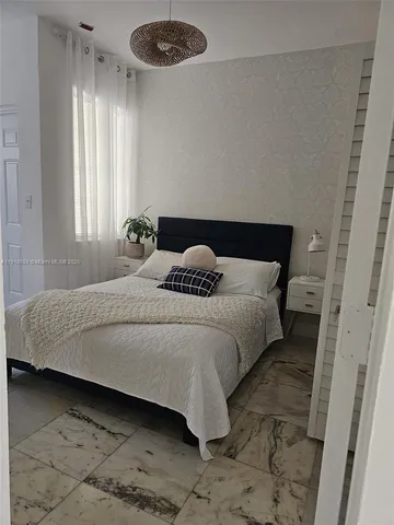 a bedroom with a bed and window