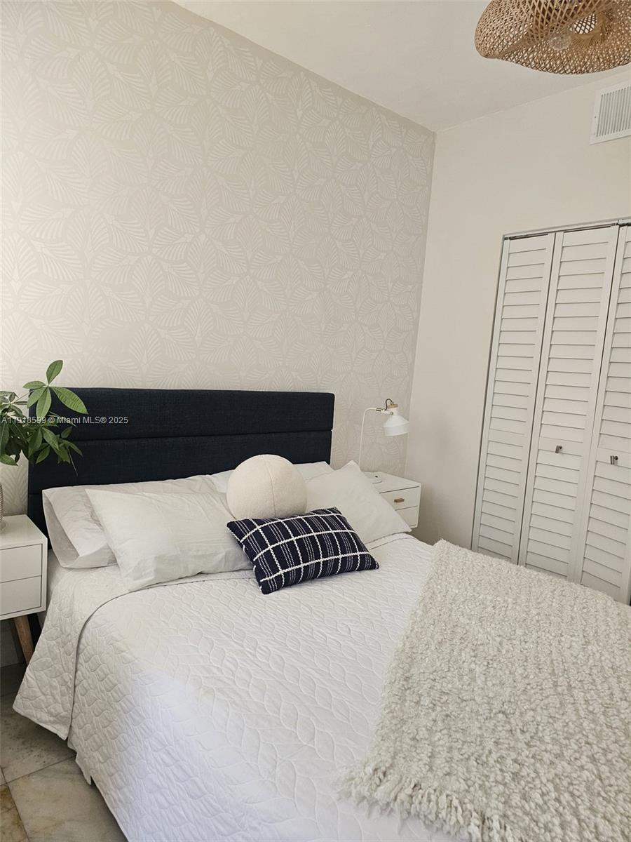 801 8th Street, Unit 201 Miami Beach, FL 33139 - Photo 31 of 37 a bedroom with a bed and a night stand
