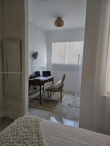 a view of a livingroom and a dining room with wooden floor