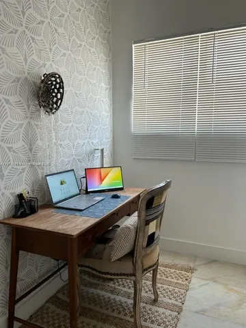 a workspace with furniture and window