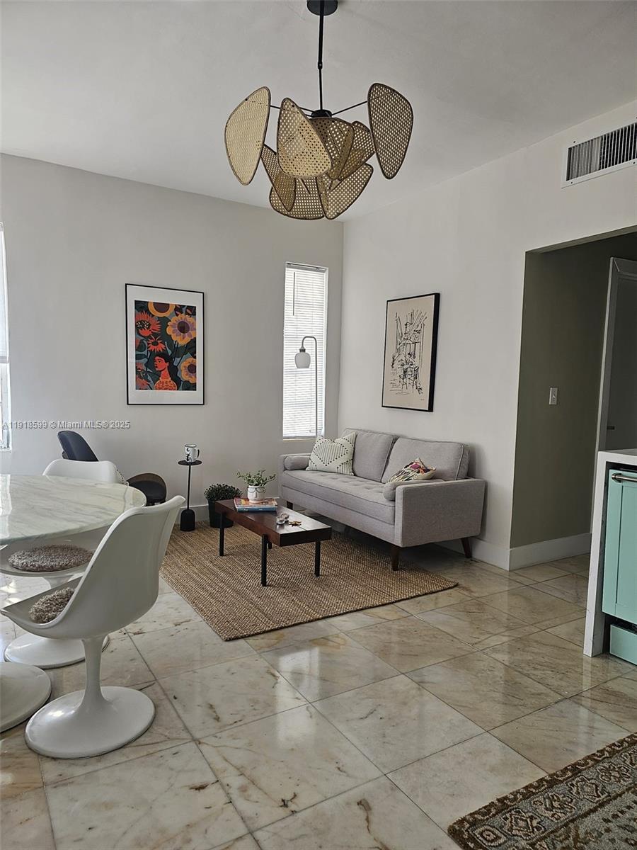 801 8th Street, Unit 201 Miami Beach, FL 33139 - Photo 4 of 37 a living room with furniture a rug and white walls