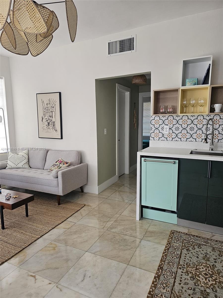 801 8th Street, Unit 201 Miami Beach, FL 33139 - Photo 9 of 37 a living room with furniture and a rug
