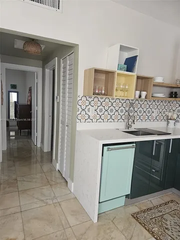 a kitchen with a sink and a refrigerator