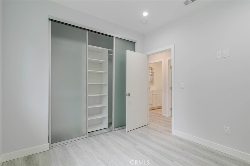 9035 Rathburn Avenue, Unit 1/2 Northridge, CA 91325 - Photo 14 of 25 an empty room with closet and wooden floor