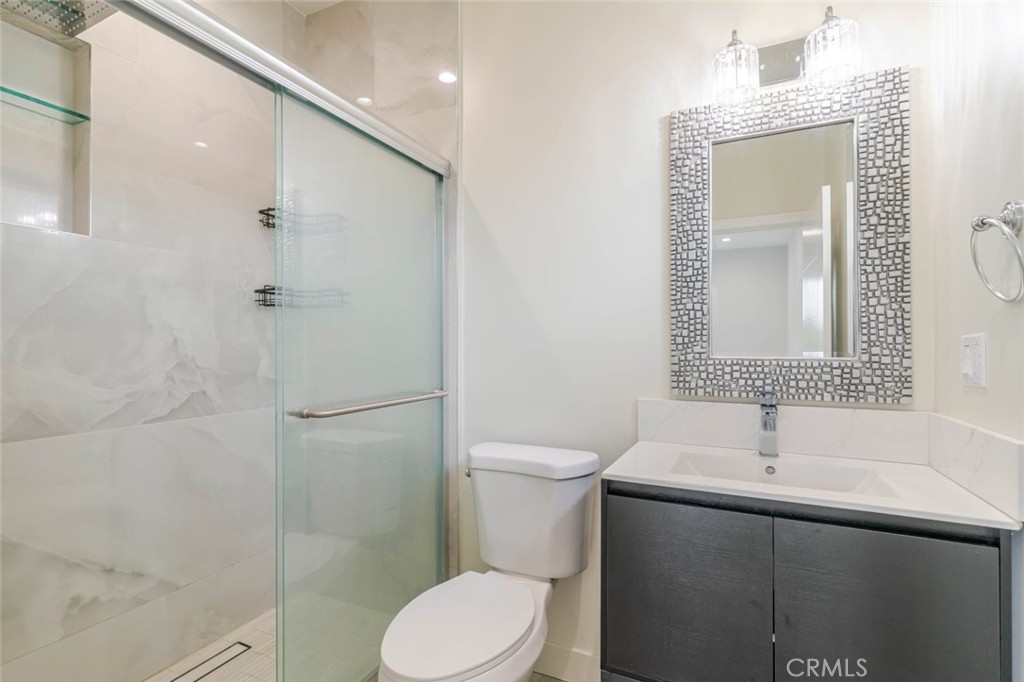 9035 Rathburn Avenue, Unit 1/2 Northridge, CA 91325 - Photo 17 of 25 a bathroom with a sink toilet and shower