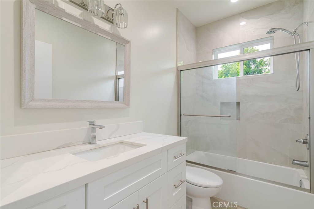 9035 Rathburn Avenue, Unit 1/2 Northridge, CA 91325 - Photo 19 of 25 a bathroom with a sink a toilet and shower