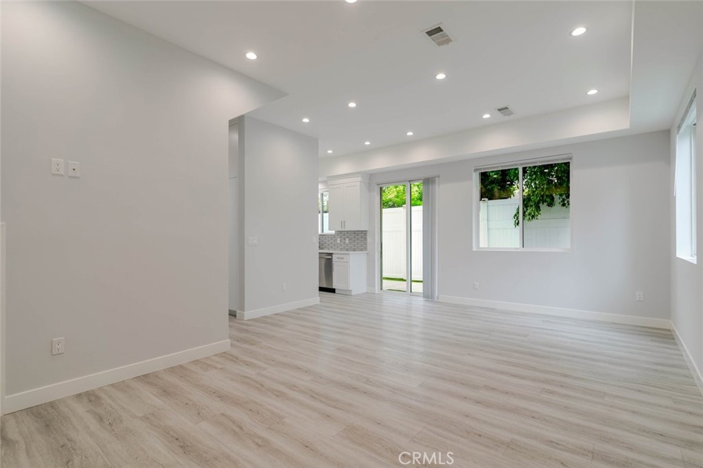 9035 Rathburn Avenue, Unit 1/2 Northridge, CA 91325 - Photo 6 of 25 a view of an empty room with wooden floor and a window