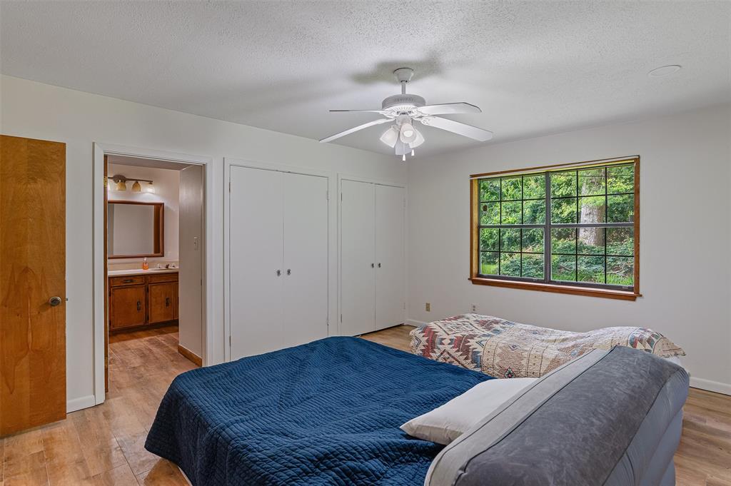 10307 Pirogue Road Oil City, LA 71061 - Photo 16 of 36 a bedroom with a bed and a chandelier