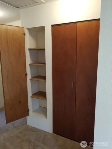 a view of walk in closet with empty racks