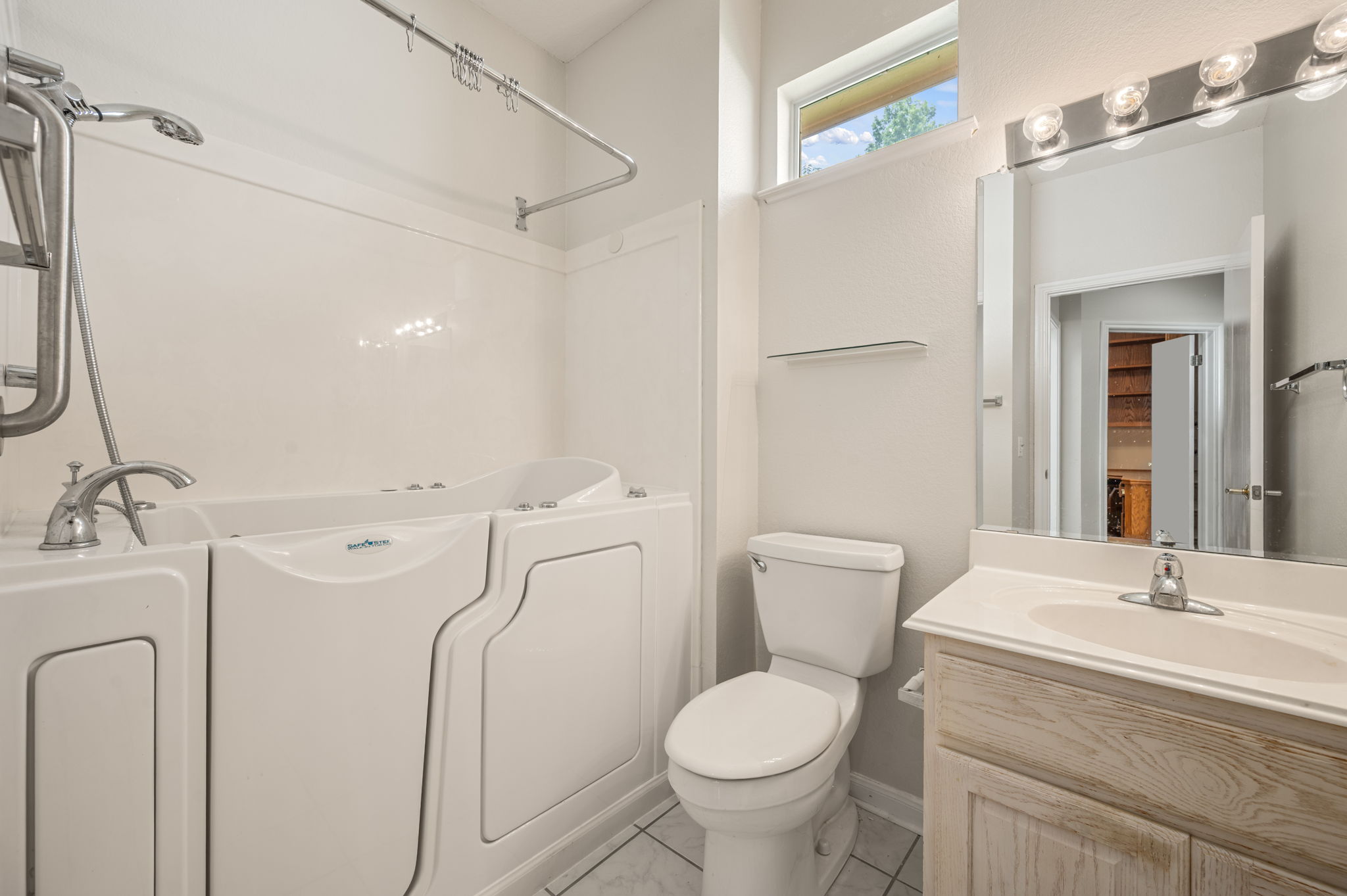 118 Bass Street Georgetown, TX 78633 - Photo 29 of 40 A well-appointed bathroom features a modern walk-in tub and vanity, promoting comfort and accessibility.