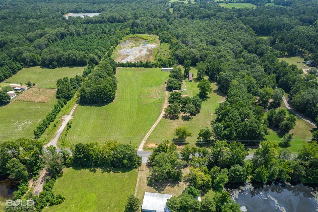 Birds eye view of property featuring a rural view and a water view