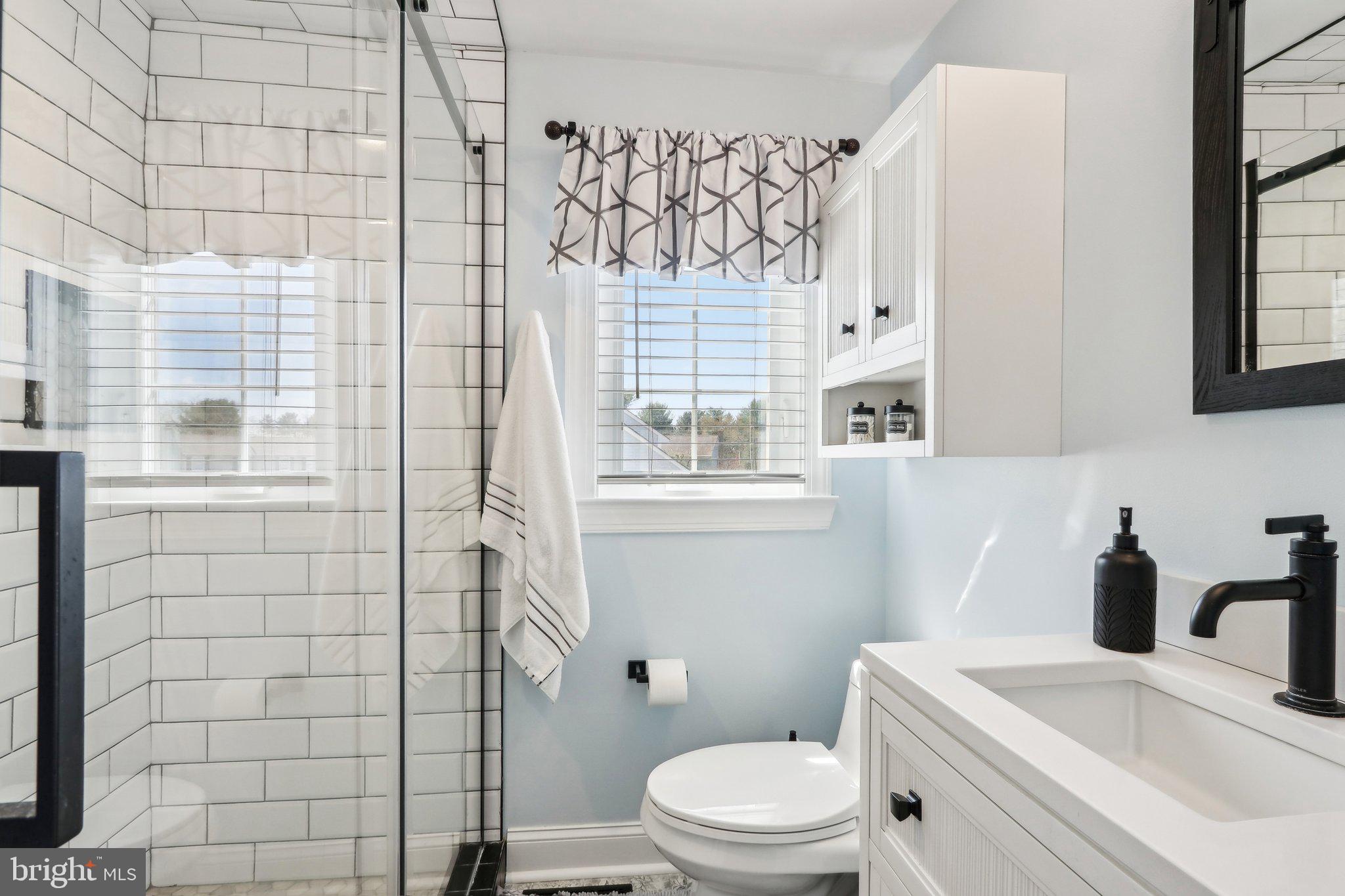 23 Yale Road Marlton, NJ 08053 - Photo 24 of 42 a bathroom with a sink a toilet and shower curtain