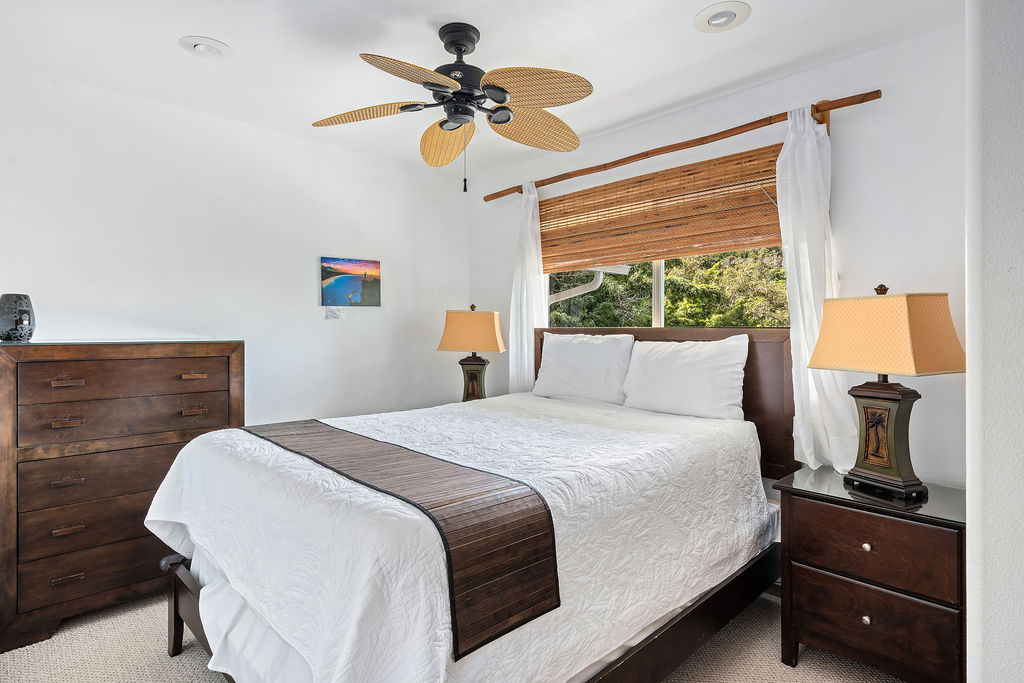 1444 East Kuiaha Road Haiku, HI 96708 - Photo 12 of 30 a bedroom with a bed and a chandelier