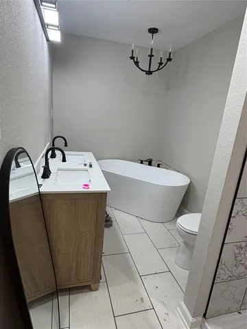 a bathroom with a sink a toilet and a mirror