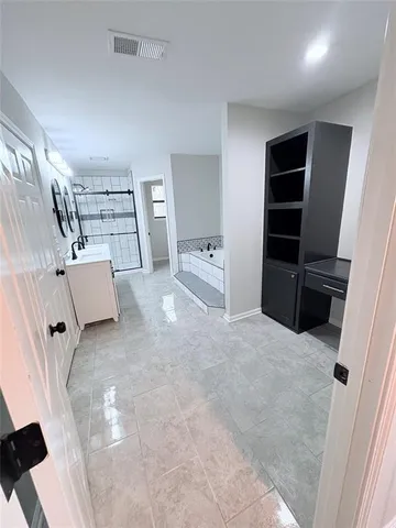 an empty room with a ceiling fan and a window