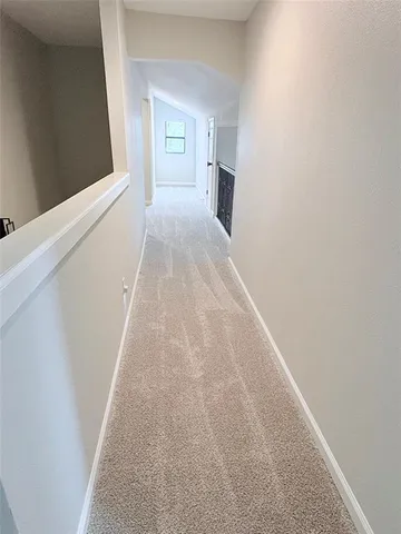 an empty room with a ceiling fan and a window