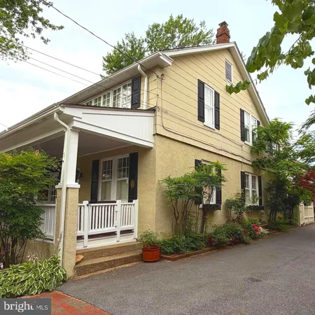 a front view of a house with plants