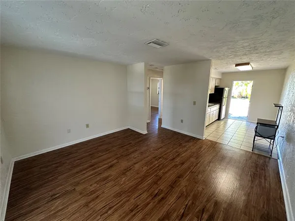 a view of a room with wooden floor and staircase