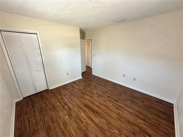 a view of a room with wooden floor