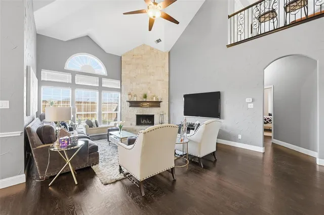 a living room with furniture a fireplace and a flat screen tv
