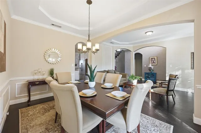 a view of a dining room with furniture a rug and wooden floor