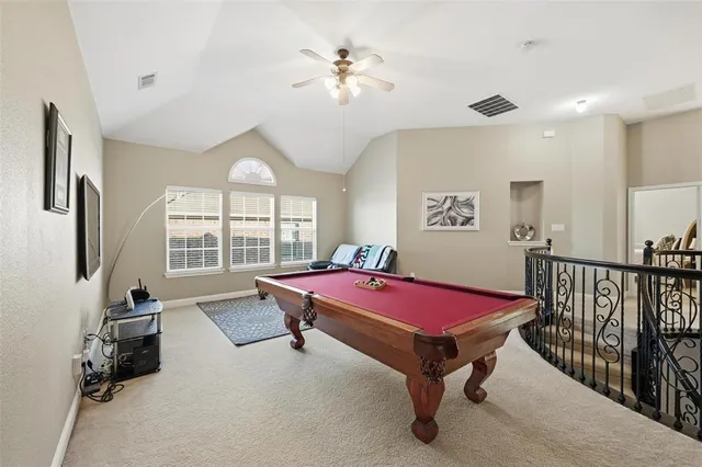 a living room with furniture pool table and a flat screen tv