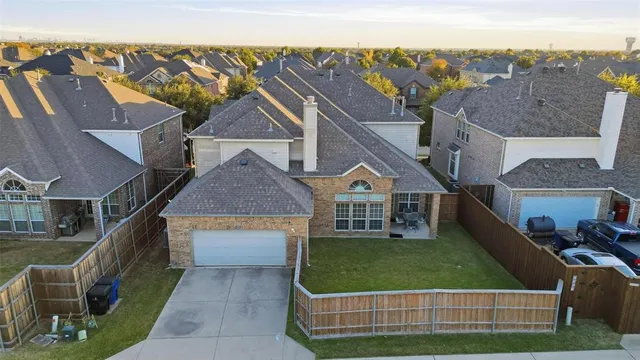 an aerial view of a house with a garden and lake view
