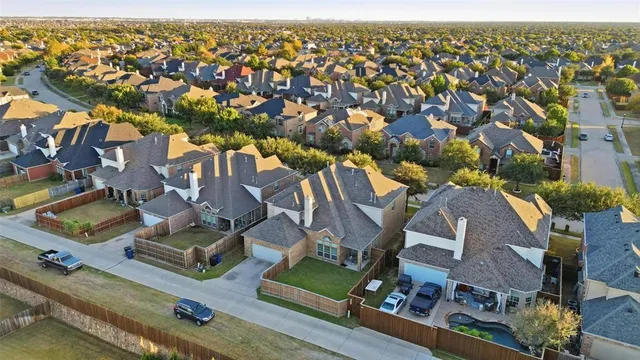 an aerial view of residential houses with outdoor space