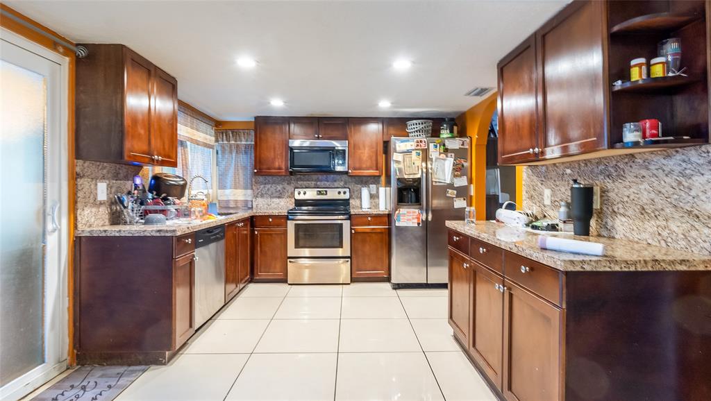 6624 Northwest 1st Court Margate, FL 33063 - Photo 11 of 17 a kitchen with stainless steel appliances granite countertop a sink a stove and a refrigerator