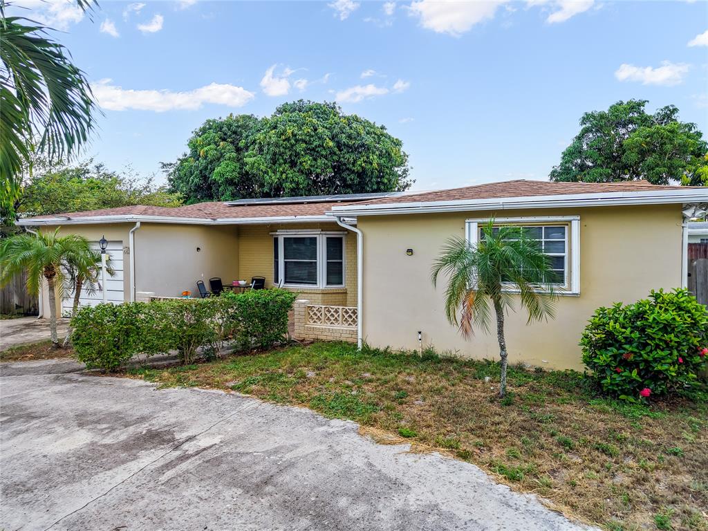 6624 Northwest 1st Court Margate, FL 33063 - Photo 2 of 17 a front view of house with yard and green space