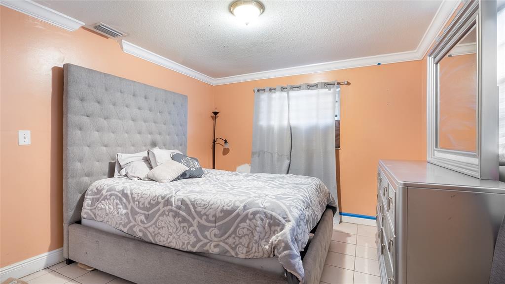 6624 Northwest 1st Court Margate, FL 33063 - Photo 3 of 17 a bedroom with a bed and a large mirror