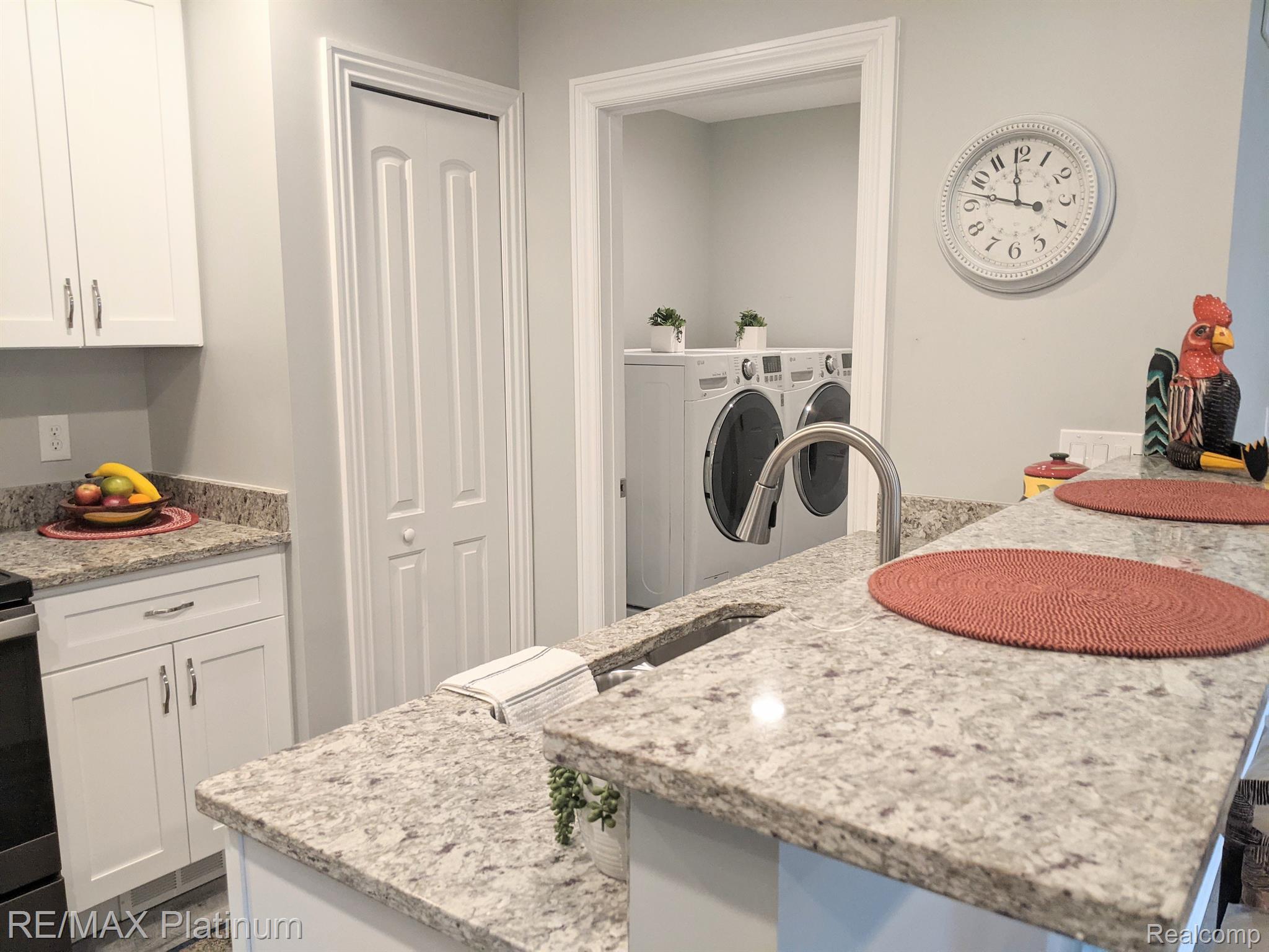 810 Chelsea Ridge Court, Unit 21 Howell, MI 48843 - Photo 17 of 43 Kitchen and adjacent laundry room