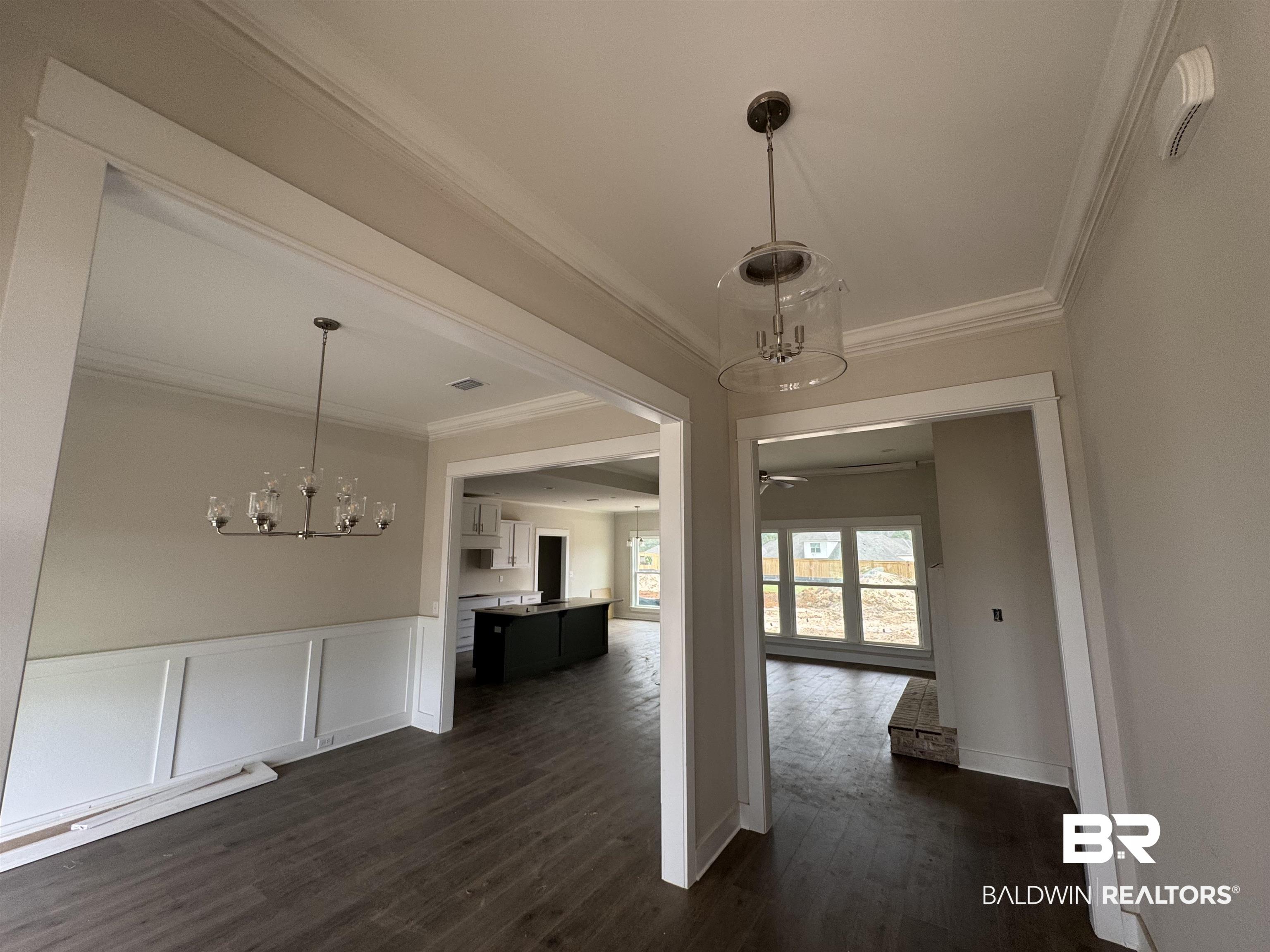 23579 Travis Stock Street Foley, AL 36535 - Photo 5 of 31 Unfurnished dining area with dark hardwood / wood-style floors, ceiling fan with notable chandelier, and crown molding
