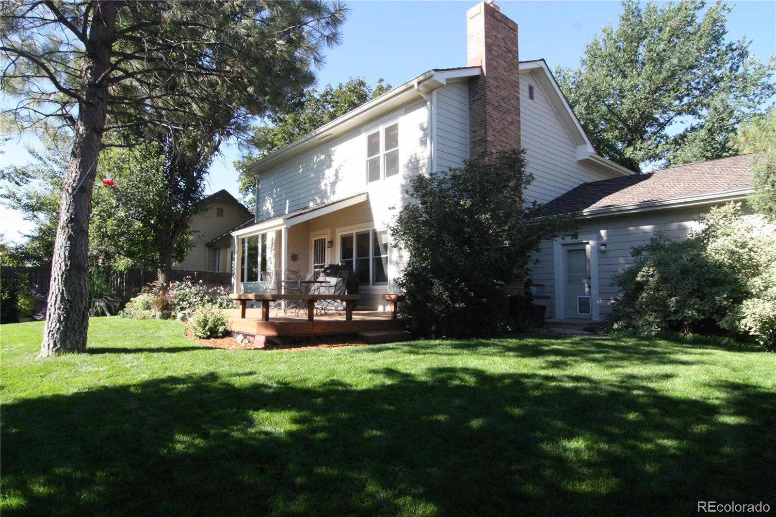 8435 Sweet Water Road Lone Tree, CO 80124 - Photo 23 of 24 a front view of house with a garden and patio