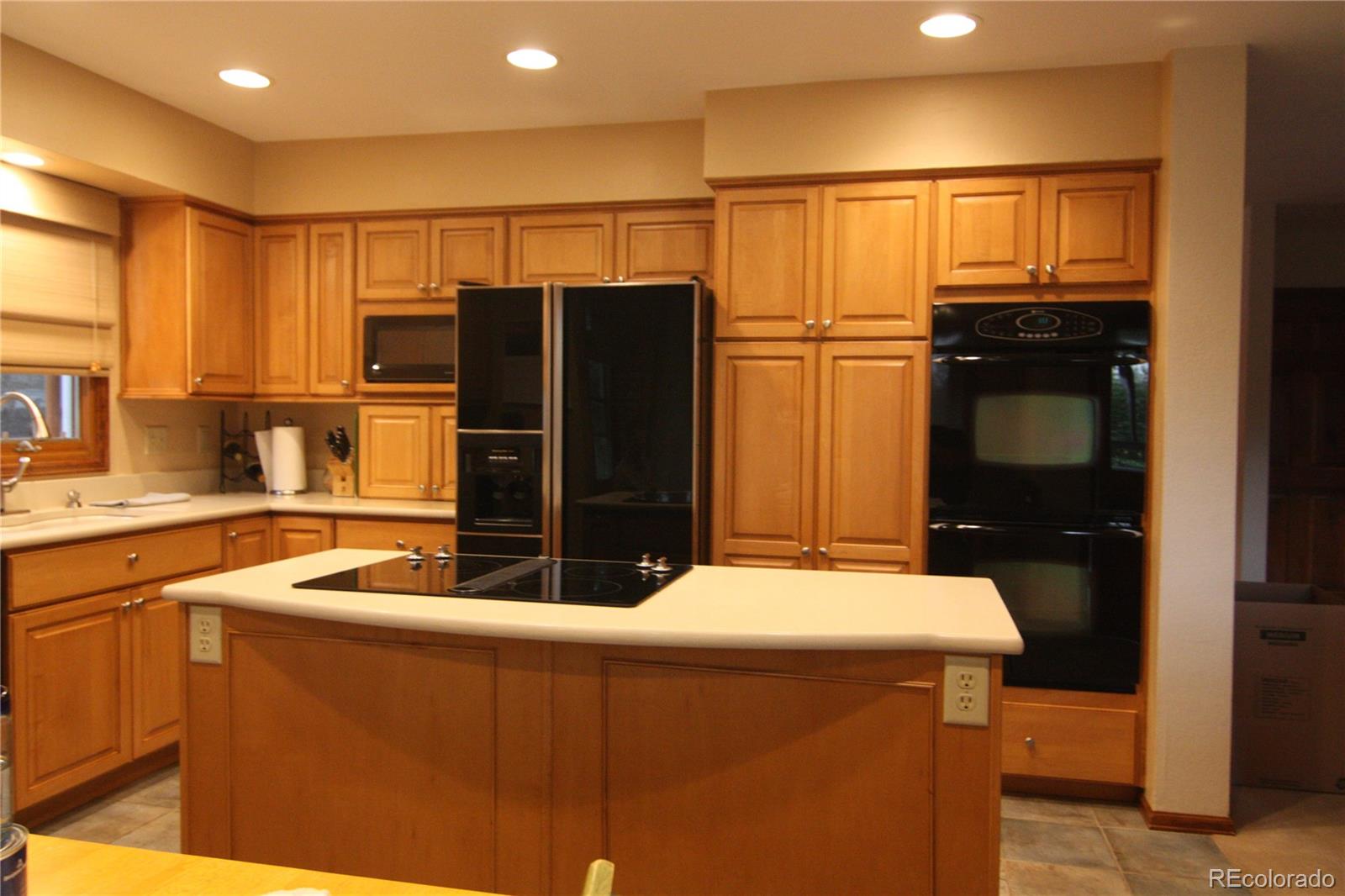 8435 Sweet Water Road Lone Tree, CO 80124 - Photo 3 of 24 a kitchen with stainless steel appliances granite countertop a refrigerator and a sink